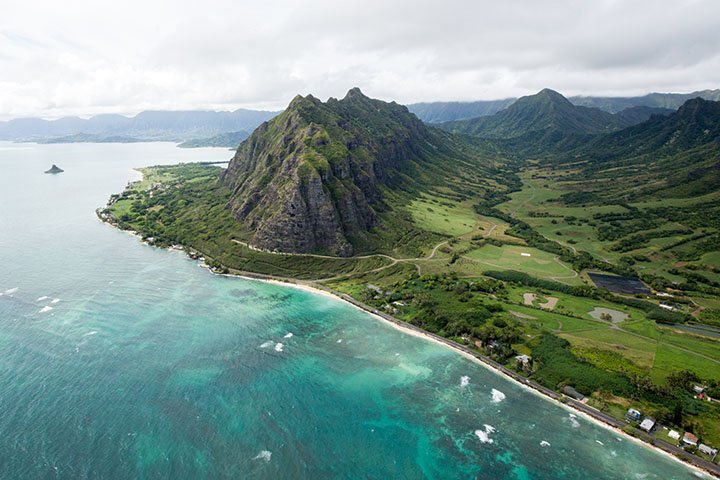 Aerial view of Kualoa valley with Chinaman's hat in the background.